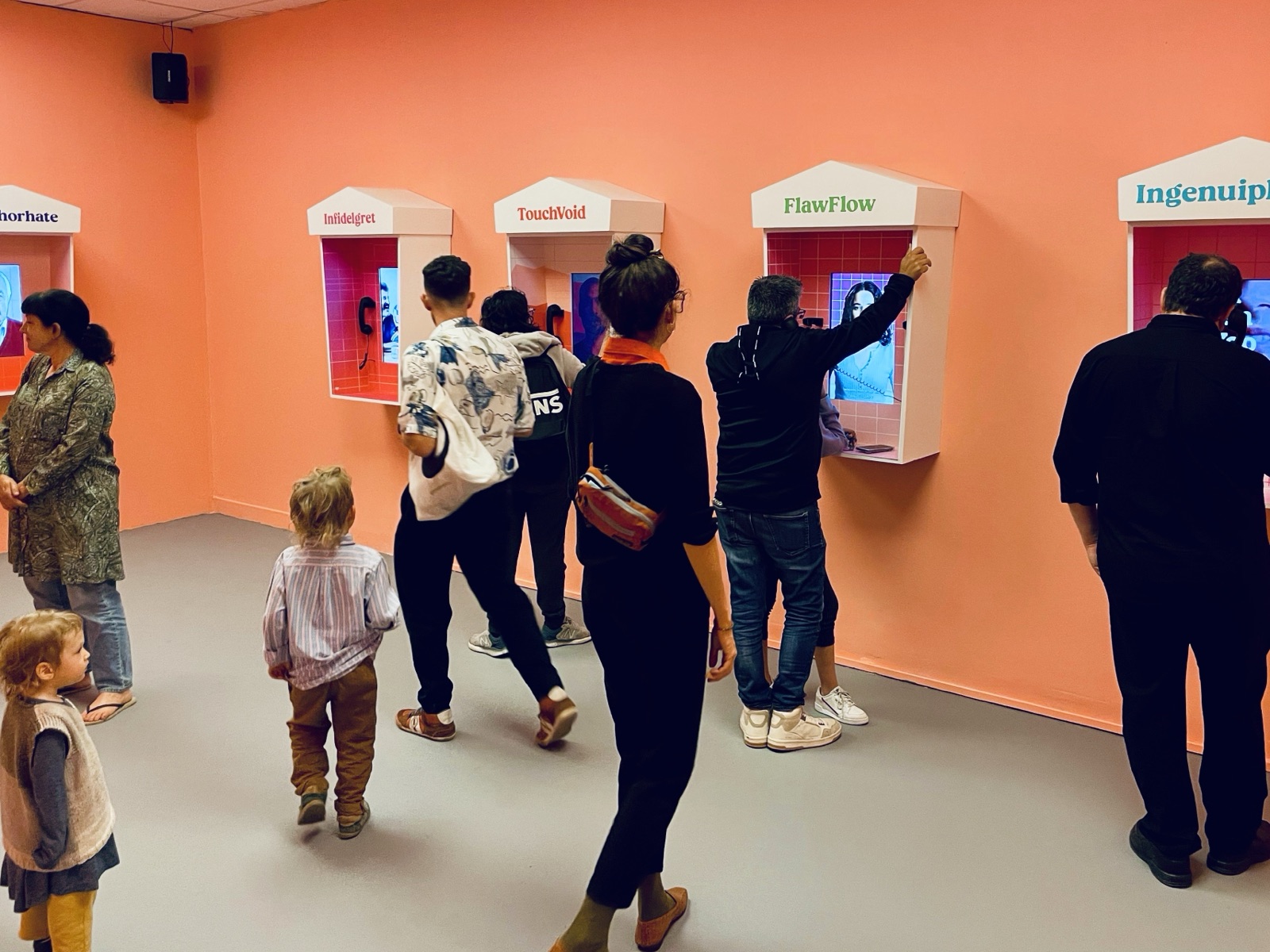 Visitors experiencing AI Relationships in the museum phone booths